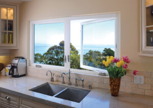 Casement windows in home kitchen, open and overlooking sea